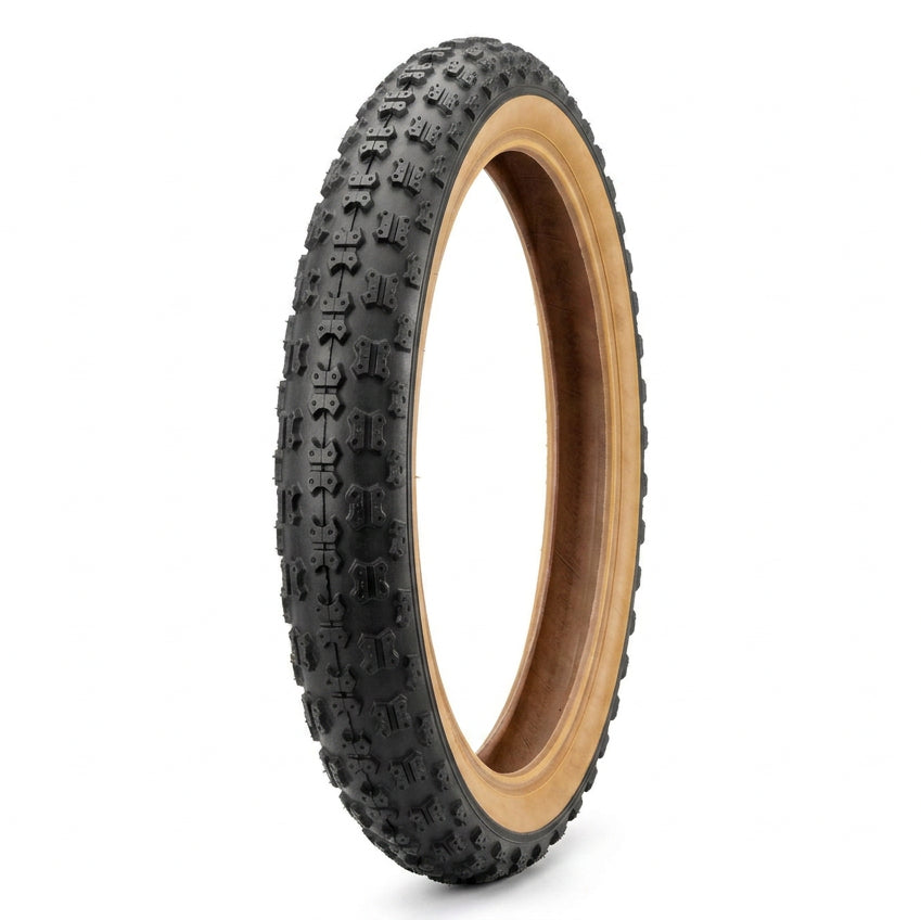 16 x 1.75 gumwall bike tyre standing upright, showing the black tread and tan sidewalls.